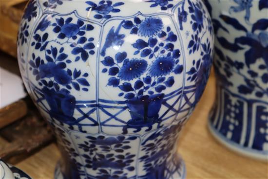 A large blue and white Chinese and a smaller similar vase with wooden cover, two stands and a cover